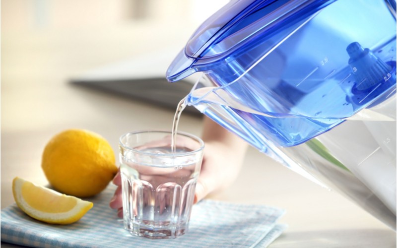 Nalivenanei filtrované vody ve sklenici a citron